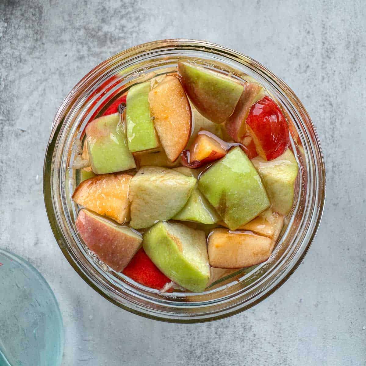 chopped apples in a jar of water.