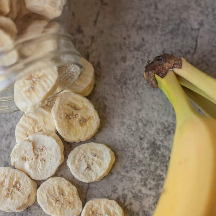 freeze-dried bananas spilling out of jar with more bananas next to it.