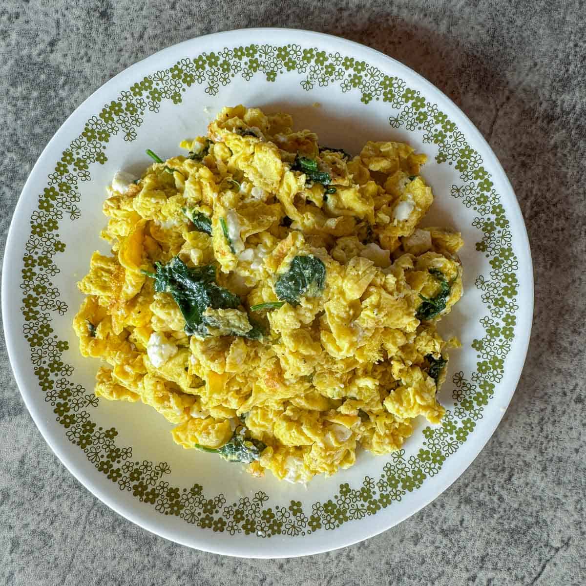 a plate with scrambled eggs and lamb's quarters.
