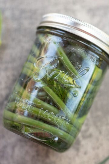 garlic scapes in a mason jar.