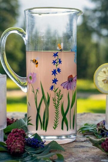 sumac lemonade in a pitcher and in 2 glasses.