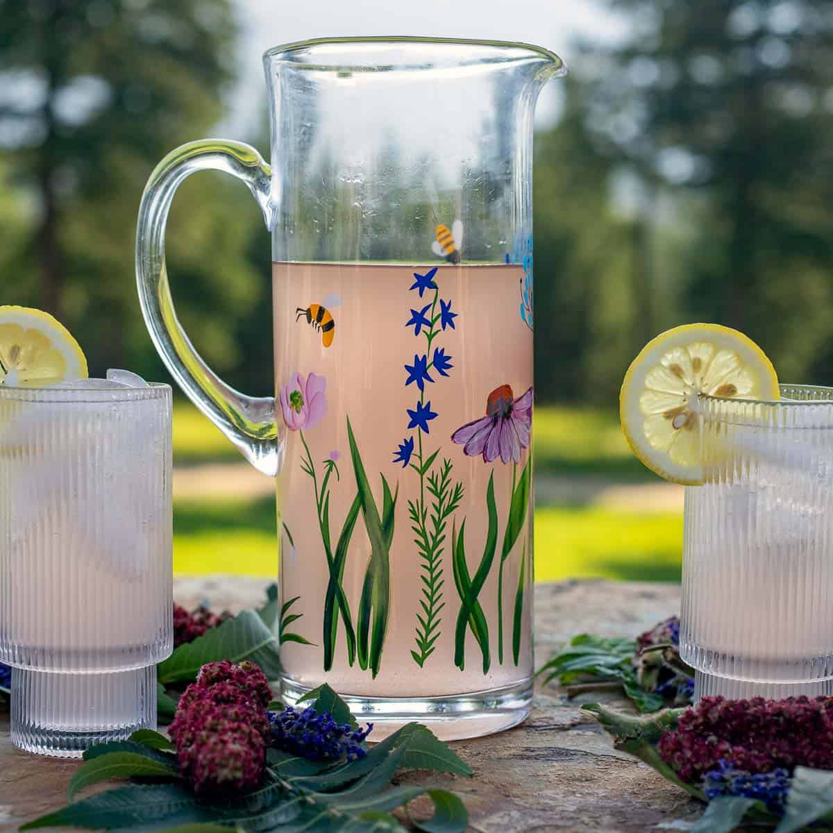 sumac lemonade in a pitcher and in 2 glasses.