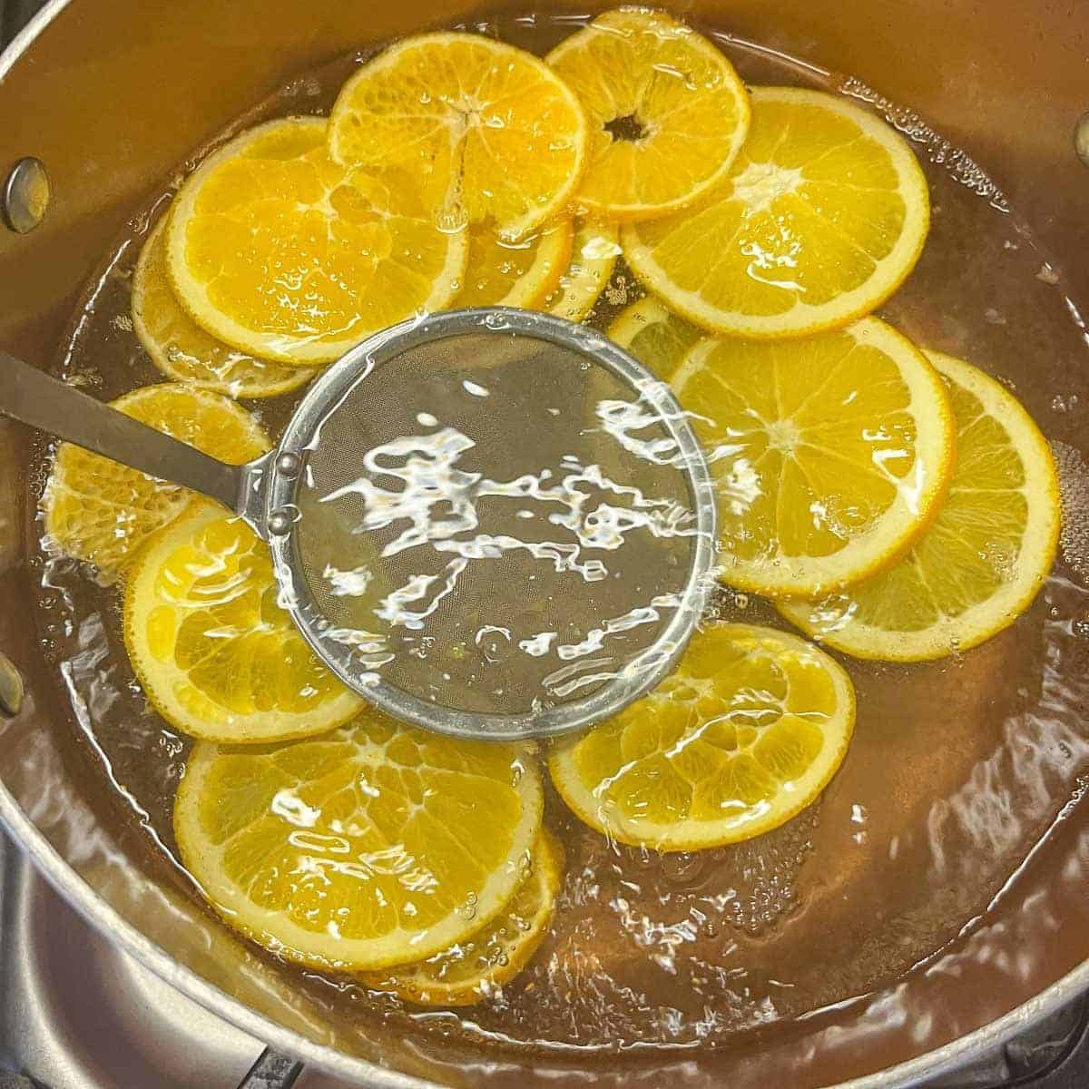 orange slices being blanched.