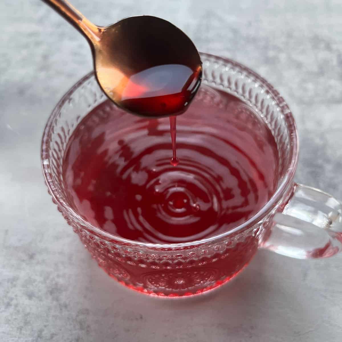 adding elderberry syrup to black elderberry tea.