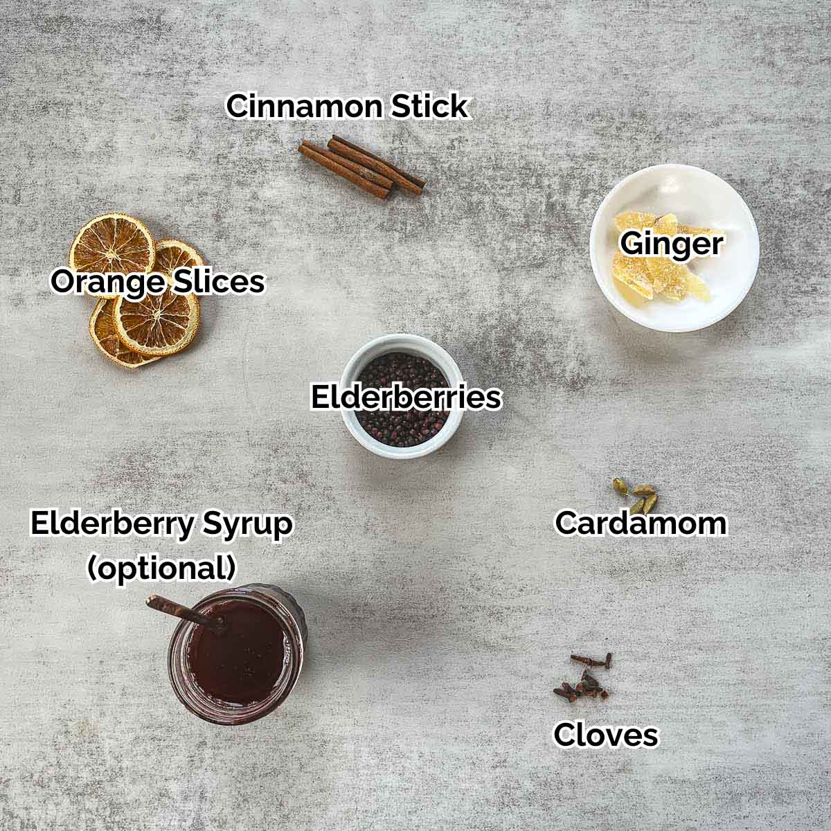 elderberry tea ingredients including elderberries, cinnamon stick, and other spices.