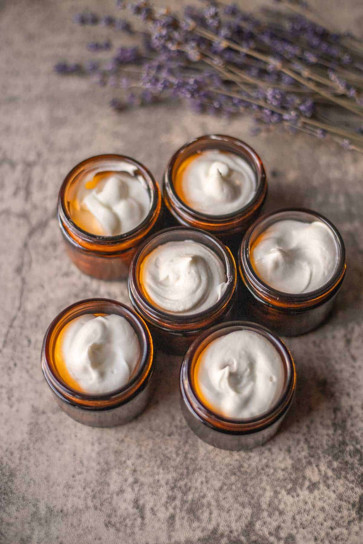whipped tallow in amber jars with lavender next to it