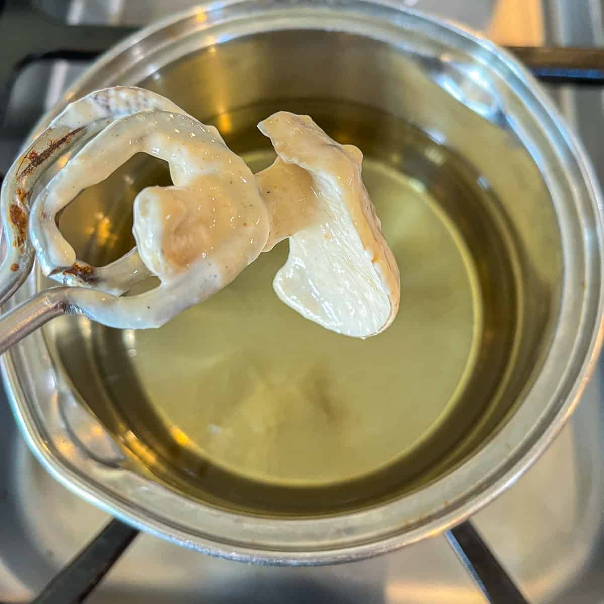 battered fried chicken mushrooms about to be fried in oil