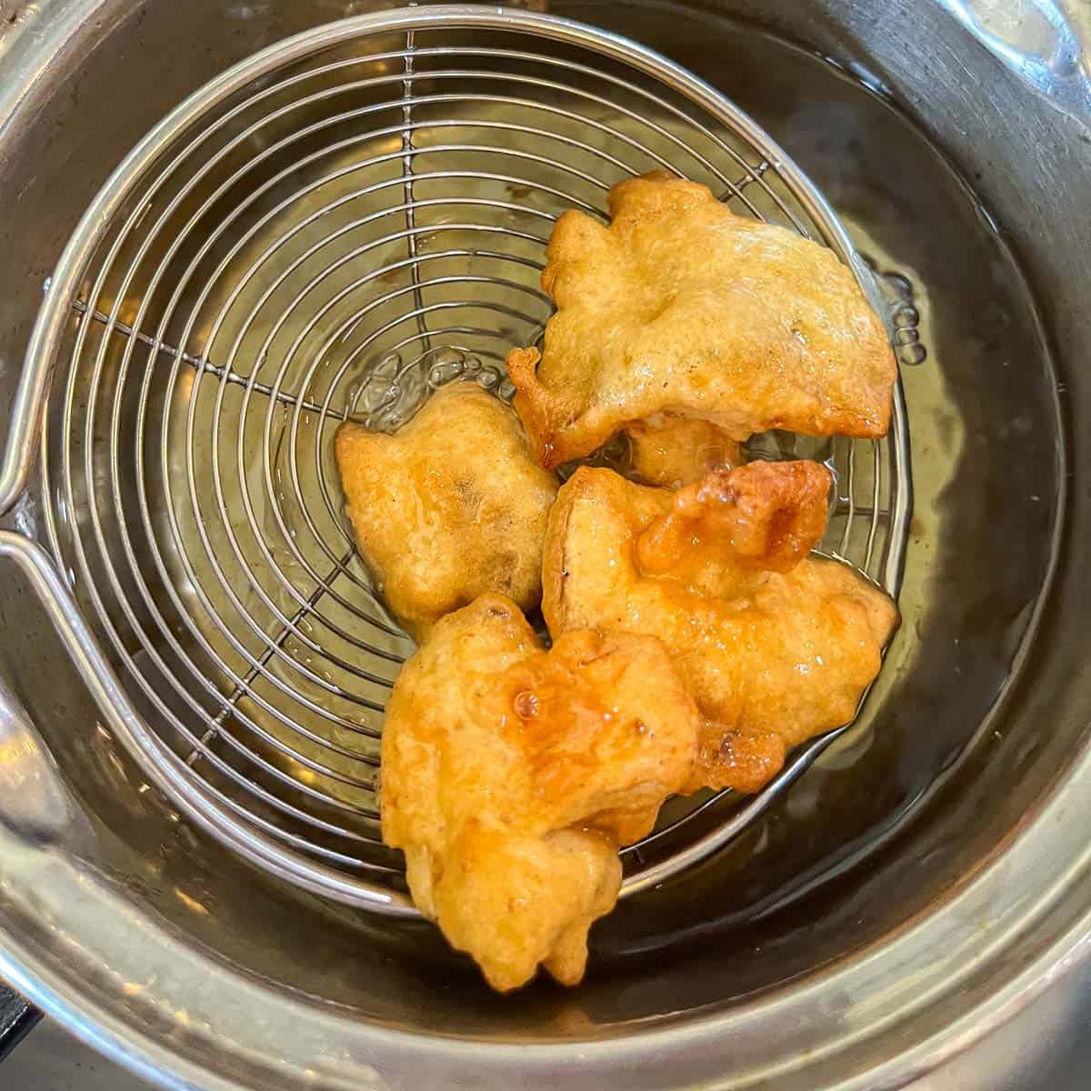 vegan fried chicken being removed from hot oil