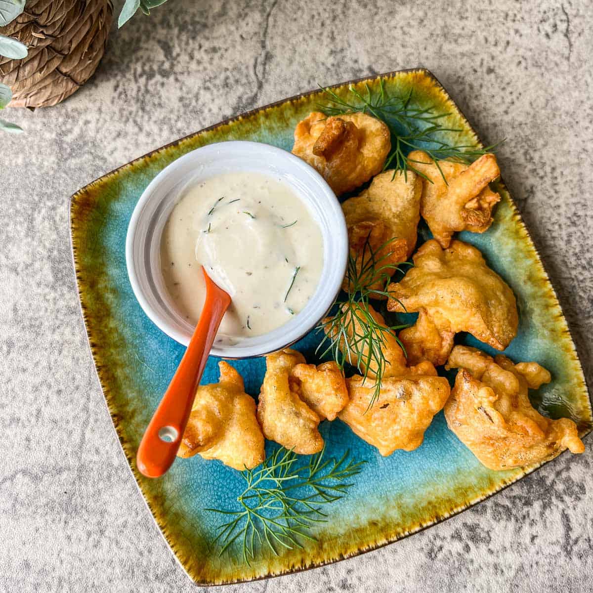 vegan fried chicken and ranch dressing with fresh dill on a square blue place