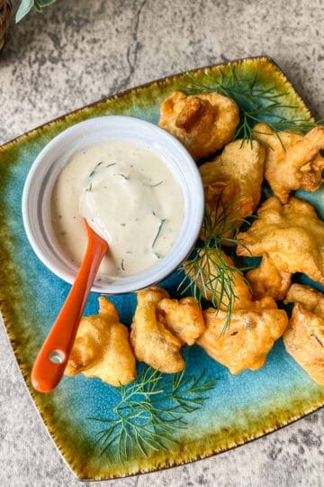 vegan fried chicken with ranch dressing on a blue plate