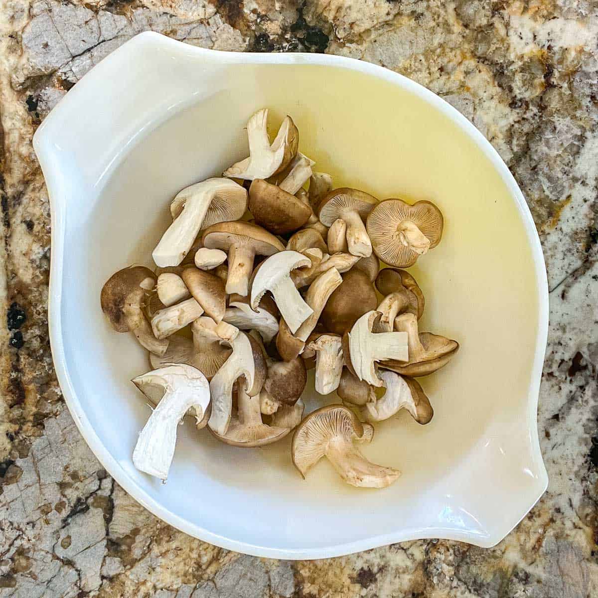 sliced fried chicken mushrooms in a white bowl