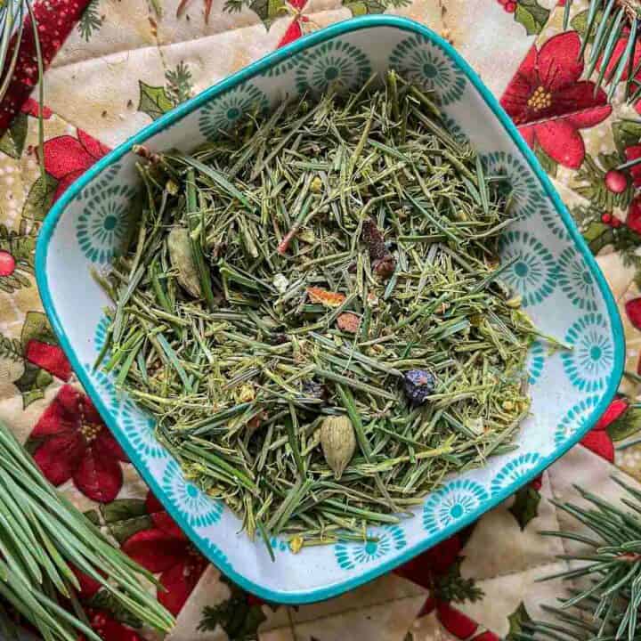 pine needle tea blend in a bowl with pine needles around it