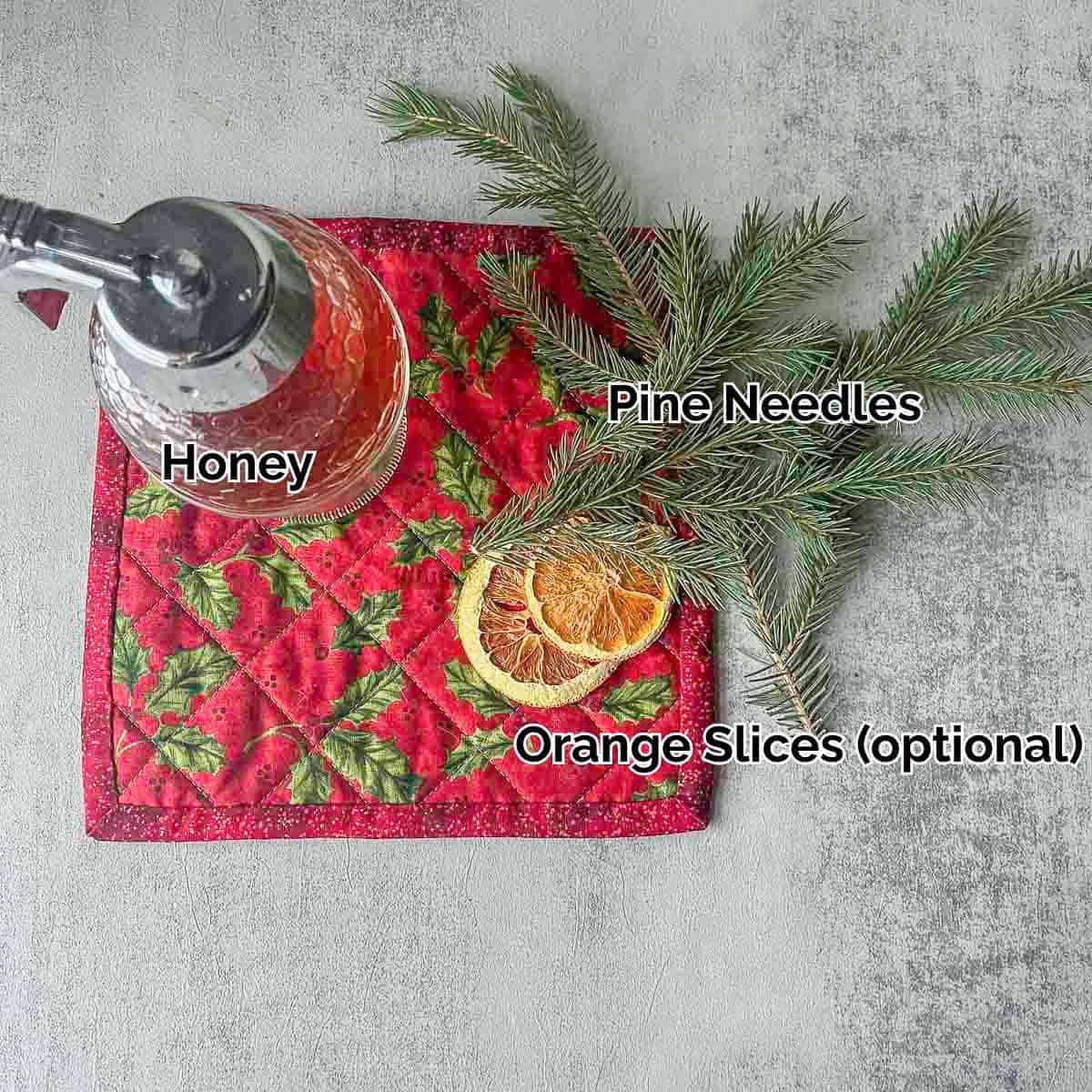pine needle tea ingredients including pine needles, orange slices, and honey