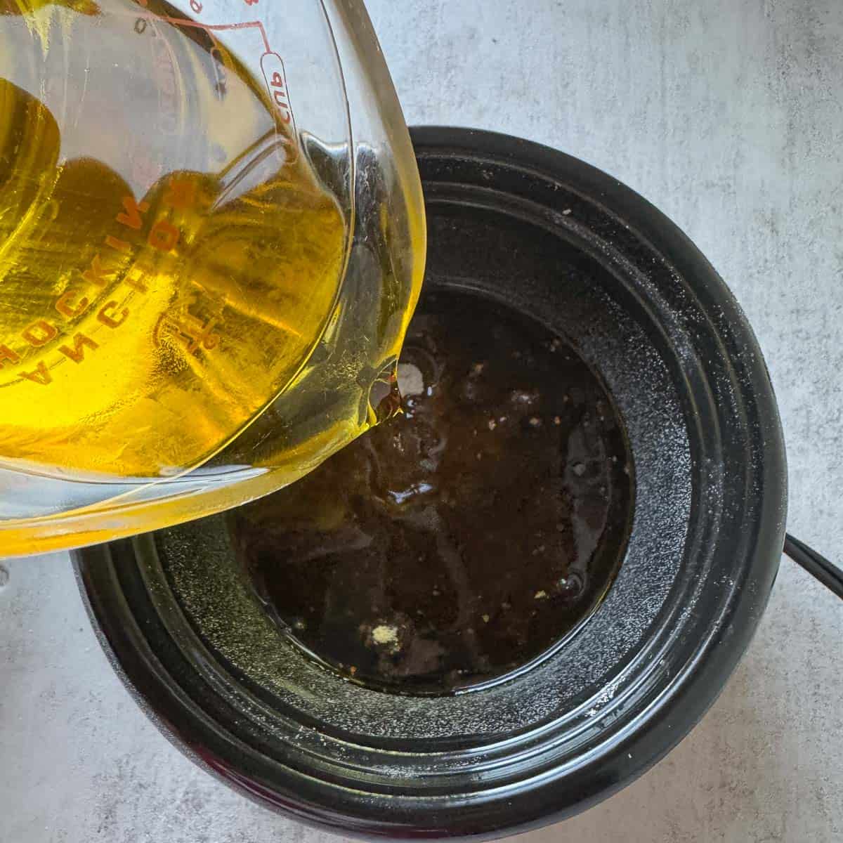 pouring oil over ground pine resin