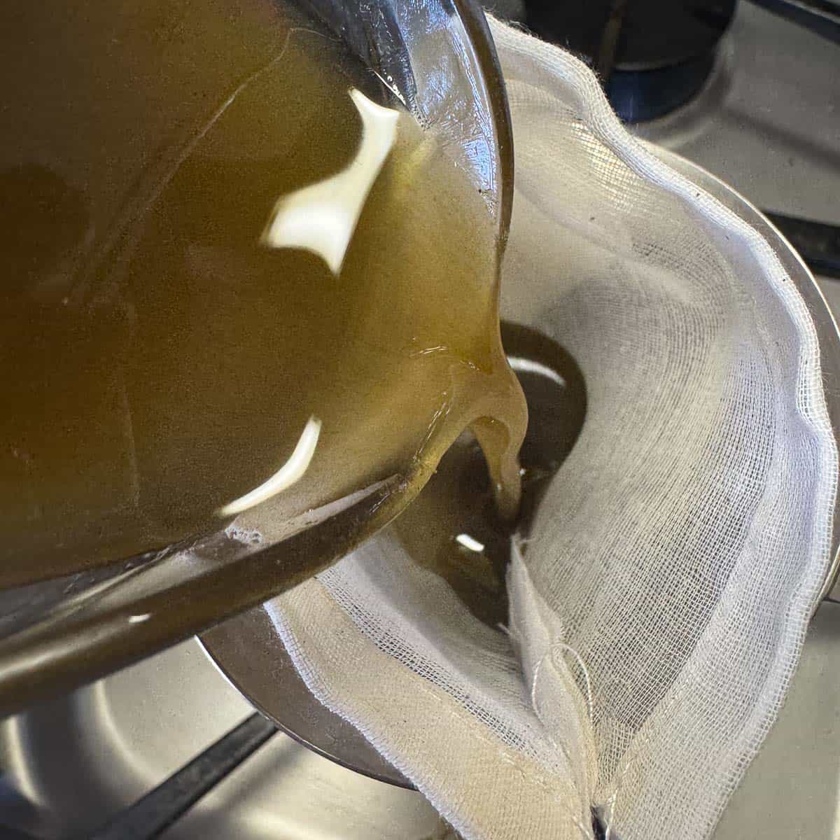 pouring resin oil through a soup bag