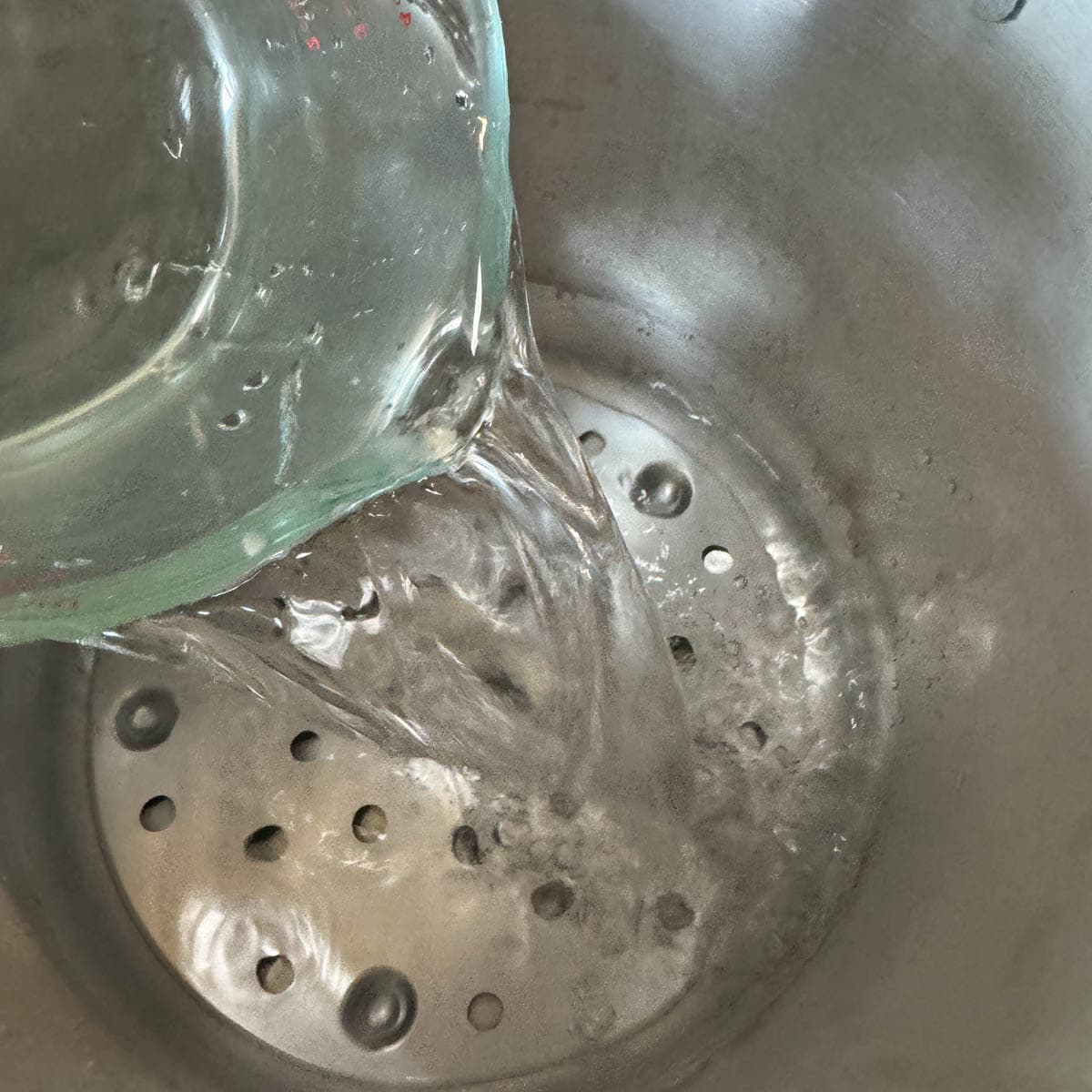 pouring water into canner