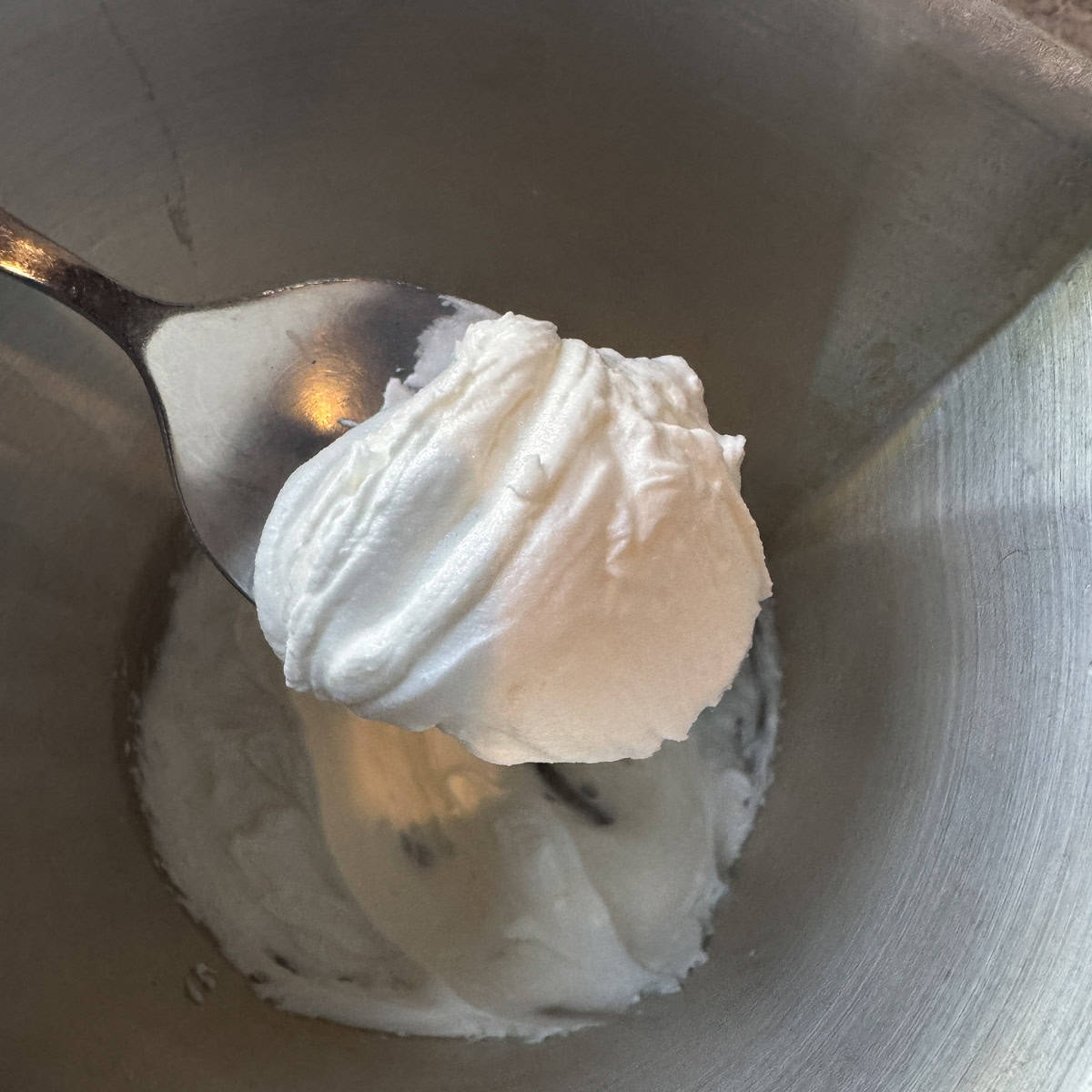 whipped tallow balm on a spoon
