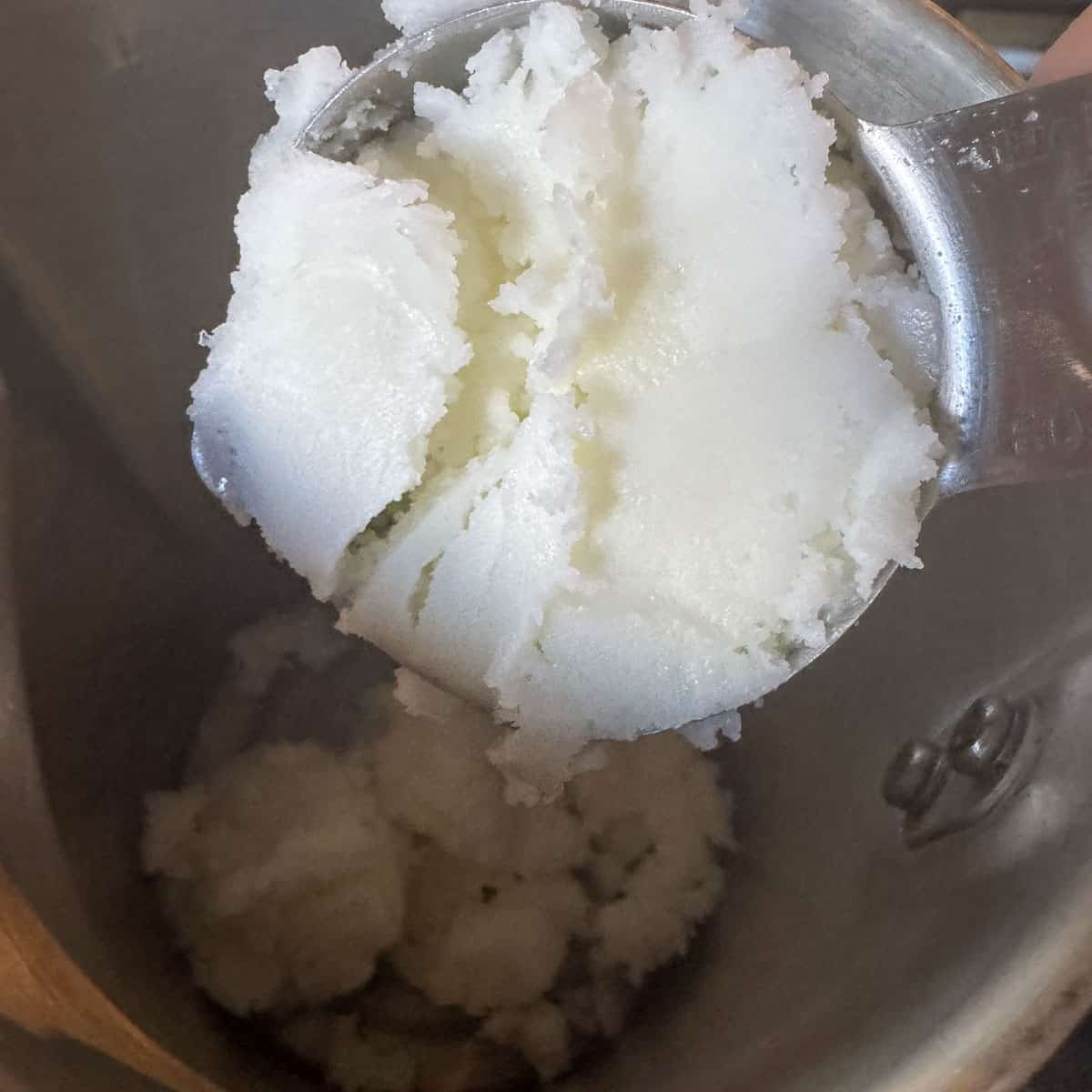 tallow being added to a pot