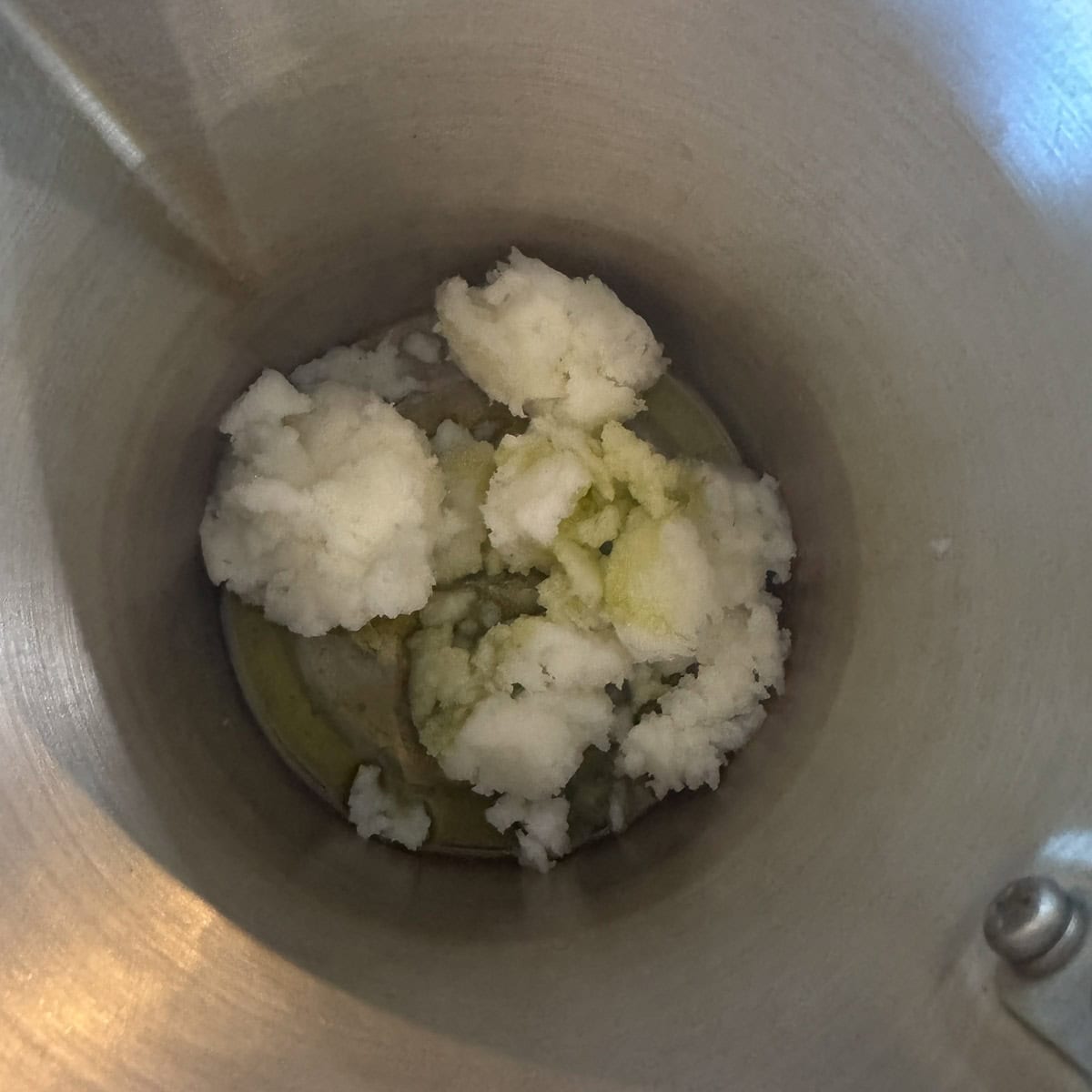 tallow and infused oil melting in a pot