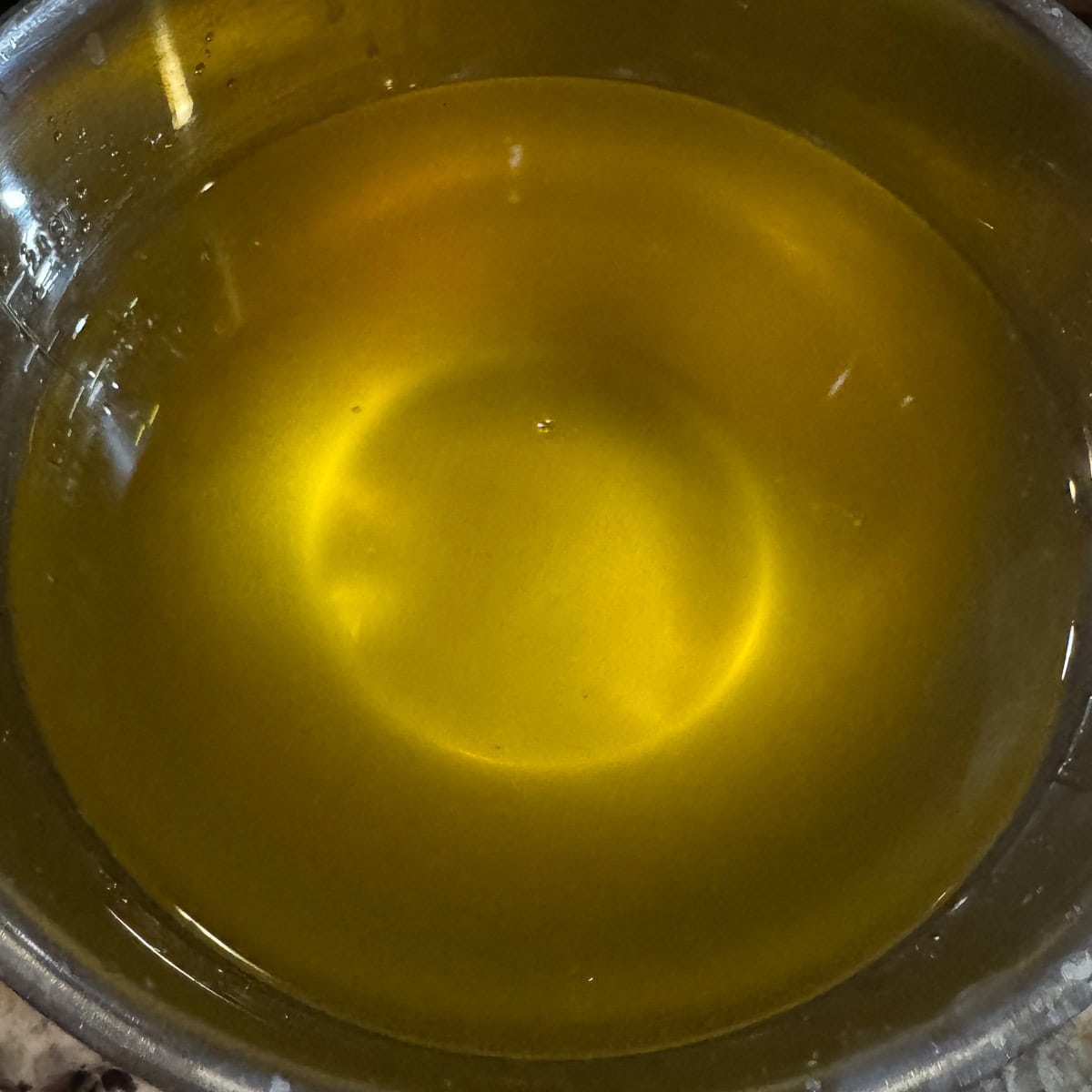 melted fat in a metal bowl
