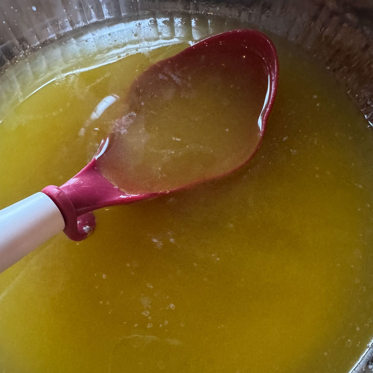 rendered tallow with a red ladle