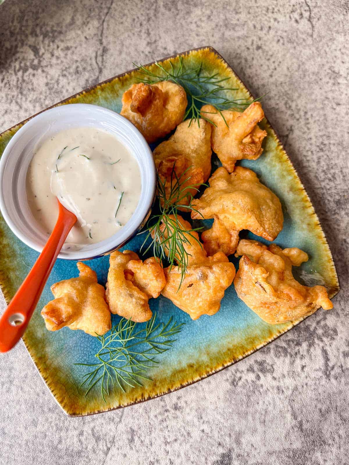 vegan fried chicken on a blue plate with ranch dressing in a small bowl