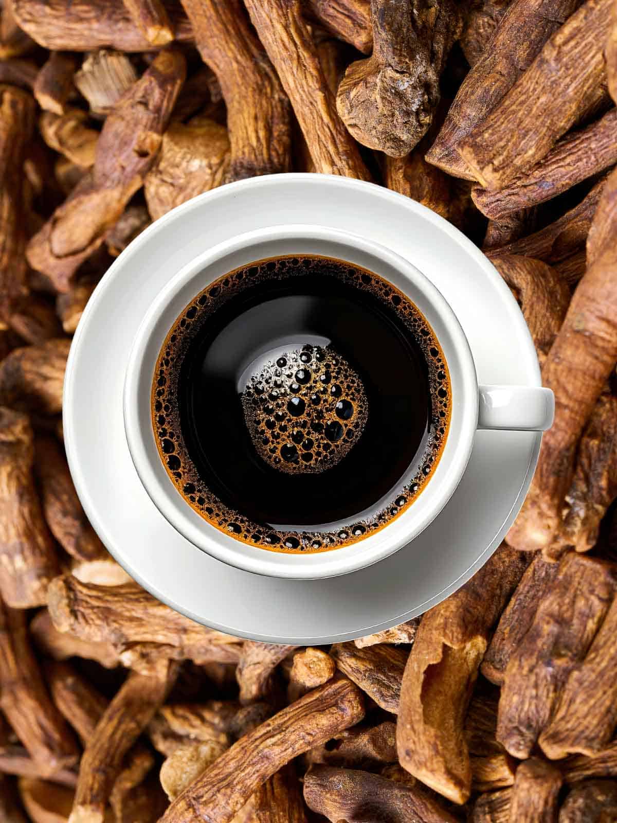 a cup of coffee on top of dandelion roots