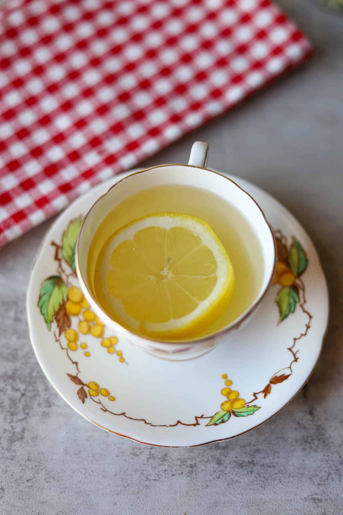 a cup of mullein leaf tea with a slice of lemon.
