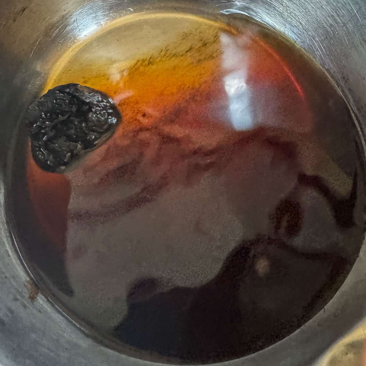 a chunk of chaga in a pot of chaga tea