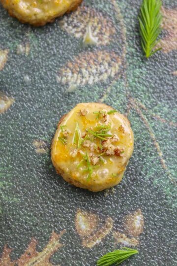 spruce tip cookies with spruce tips scattered around them