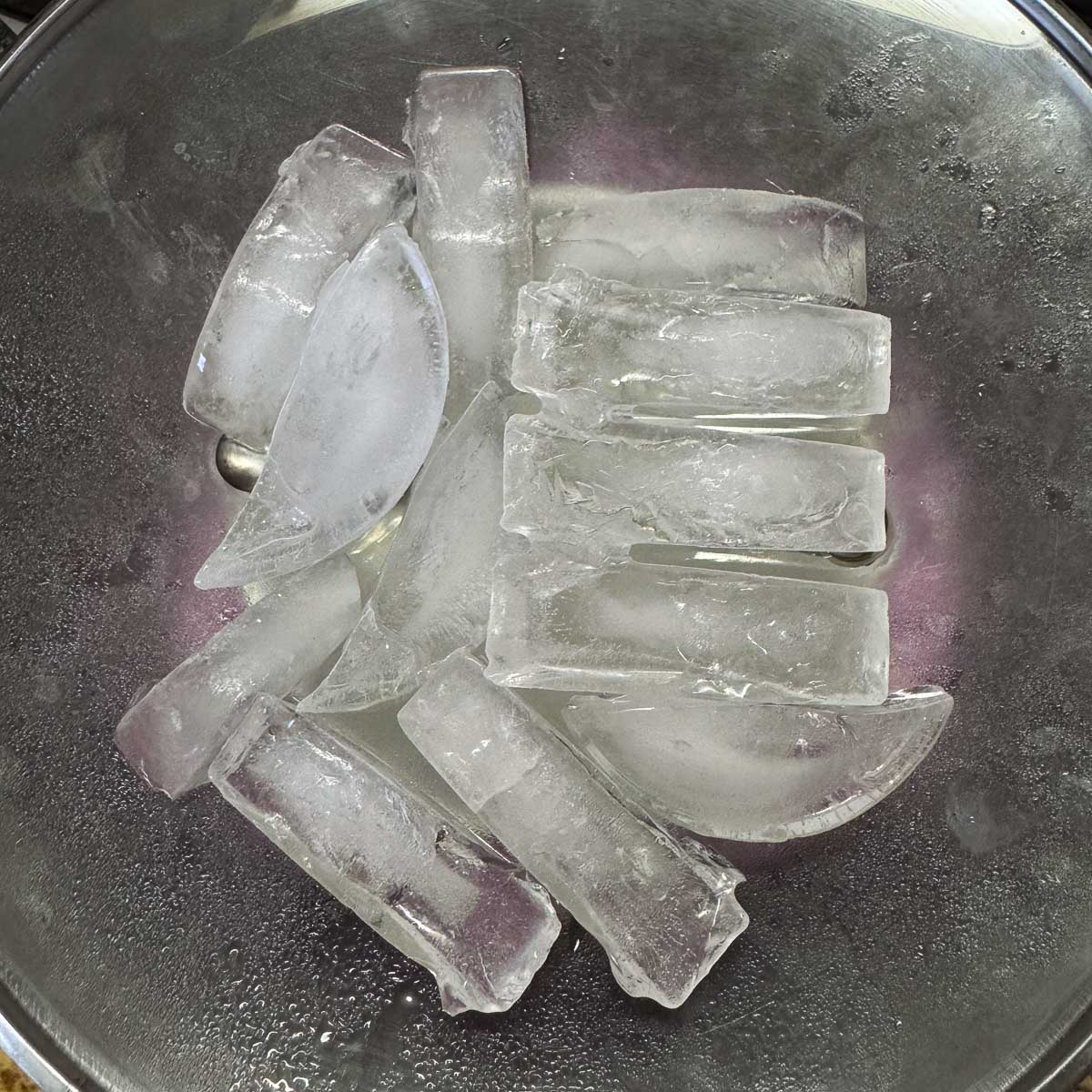 ice cubes over a pot with inverted lid