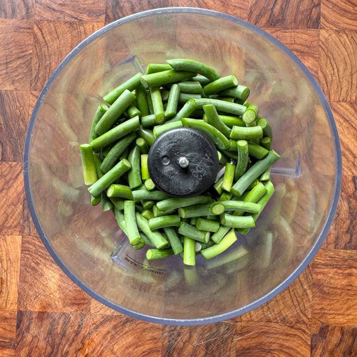 garlic scapes in a food processor