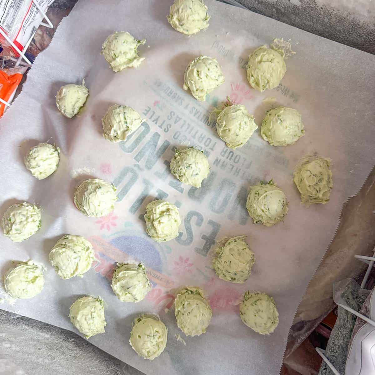 garlic scape butter scoops on parchment paper