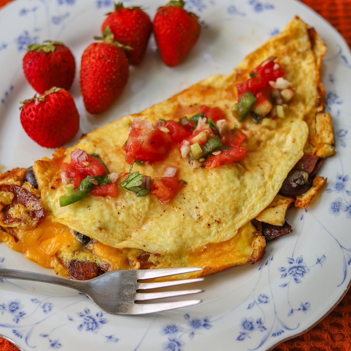 omelette with salsa and strawberries