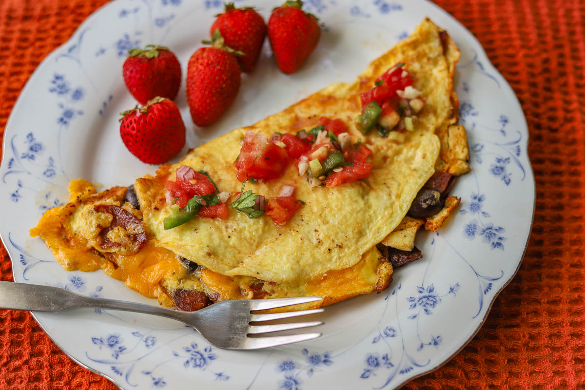 giant puffball mushroom  Omelette on a white flowered plate with strawberries