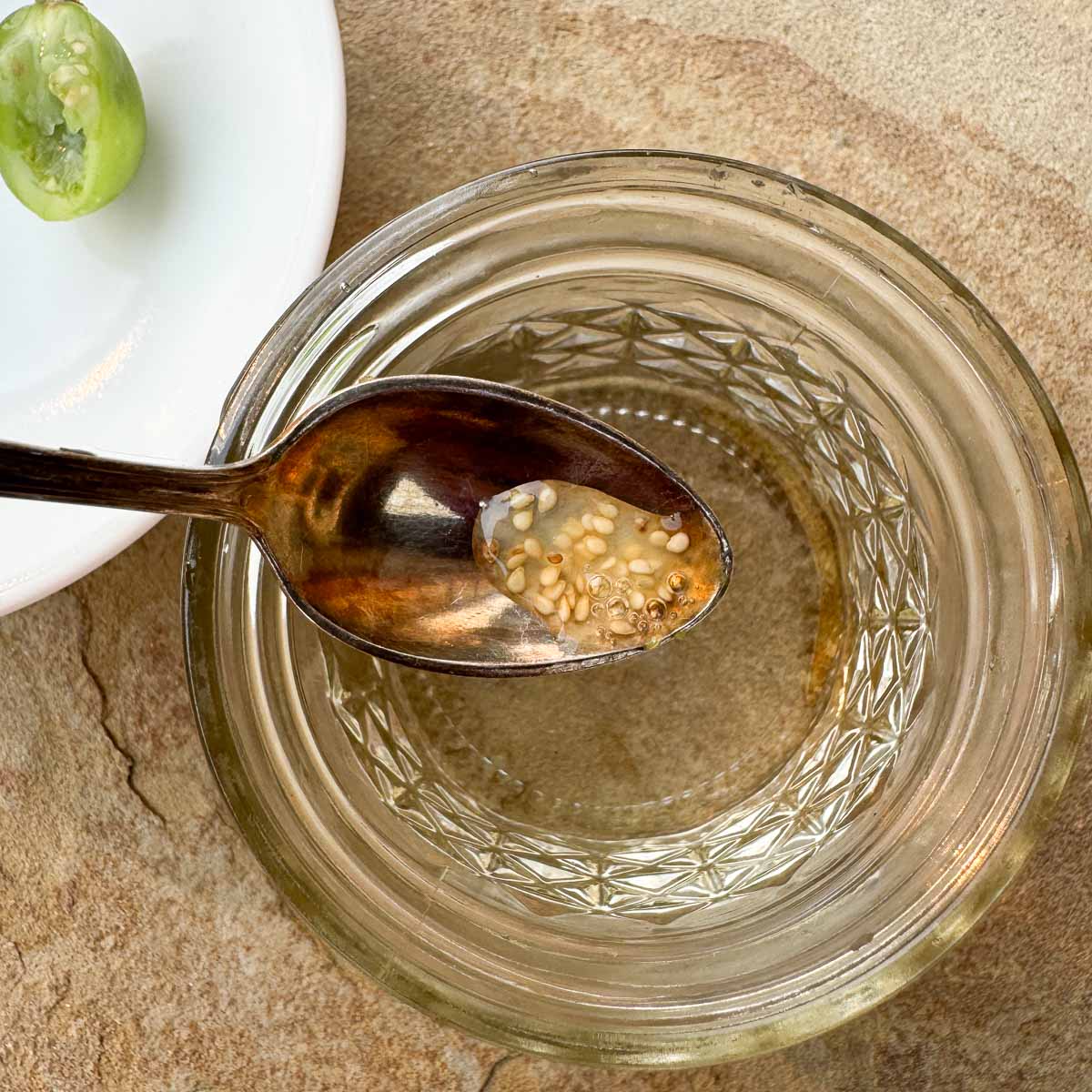 potato berry seeds in a small spoon over a mason jar