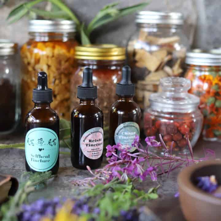 tinctures and herbs in mason jars, amber bottles and a mortar and pestle