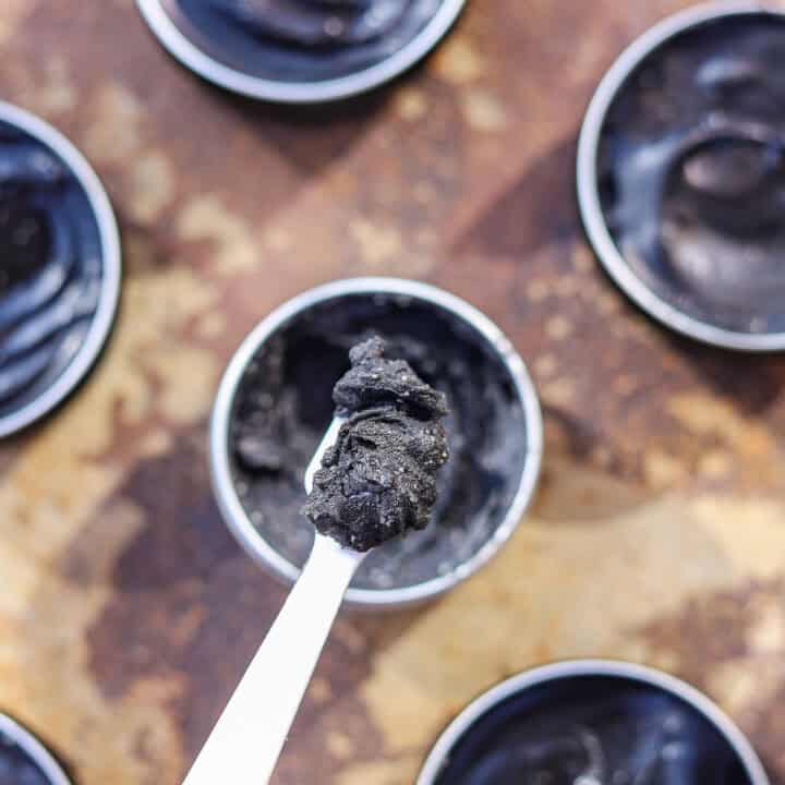 black drawing salve in tins