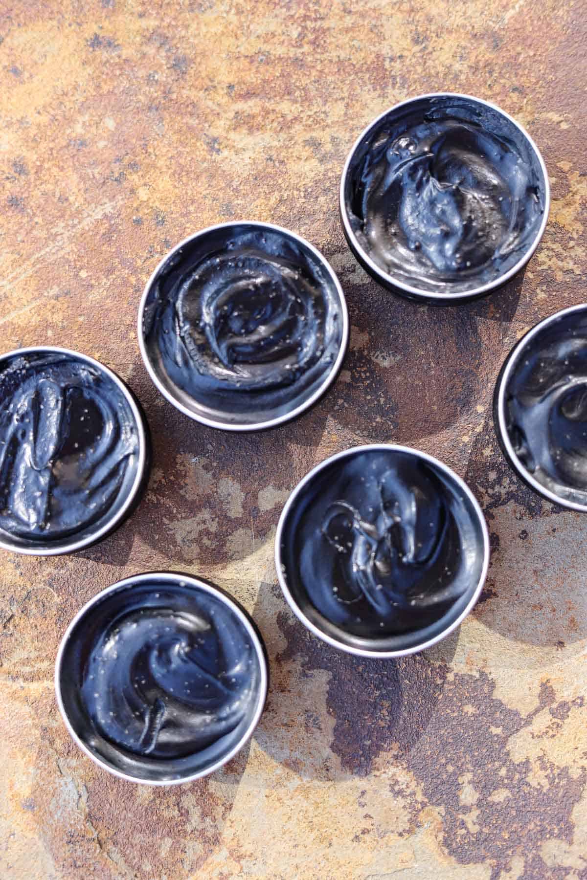 black drawing salve in tins