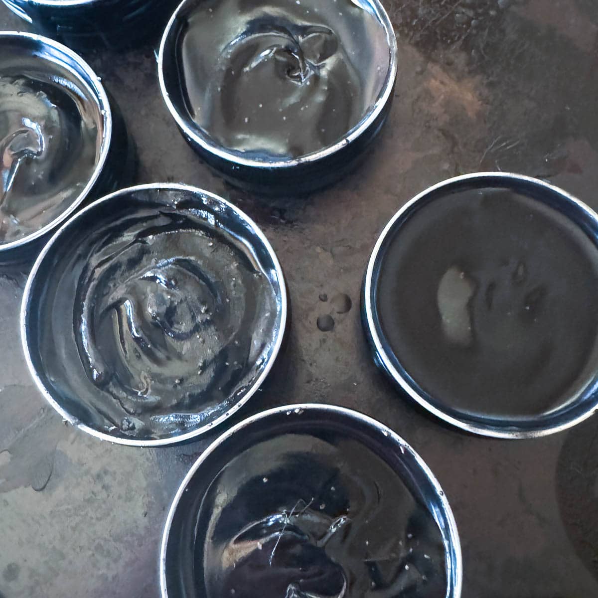 black drawing salve in small tins
