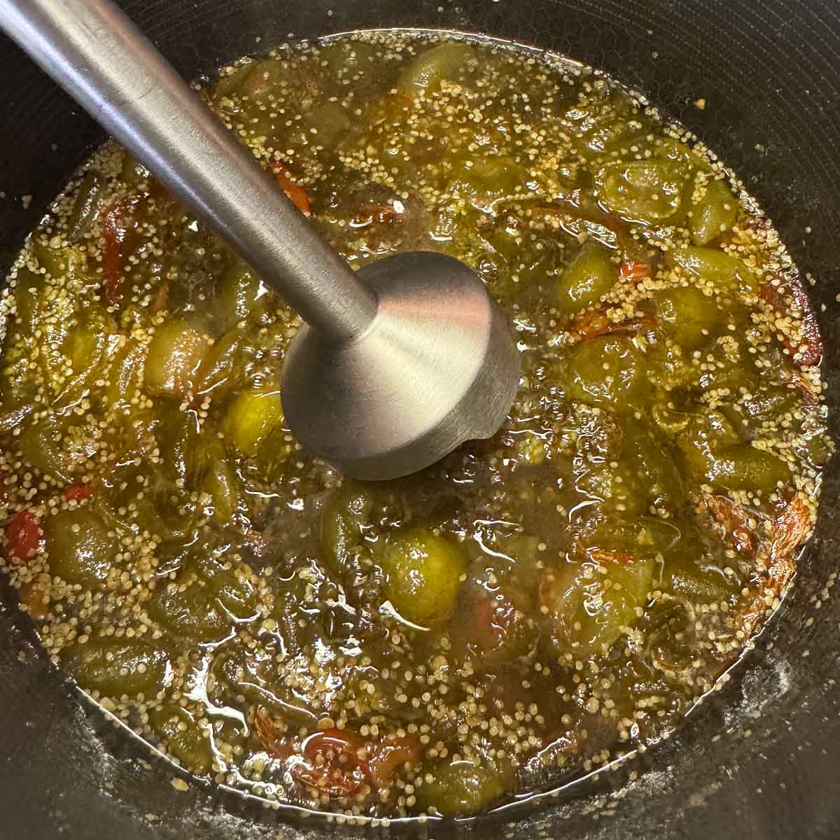 immersion blender in a pot of tomatillo jam